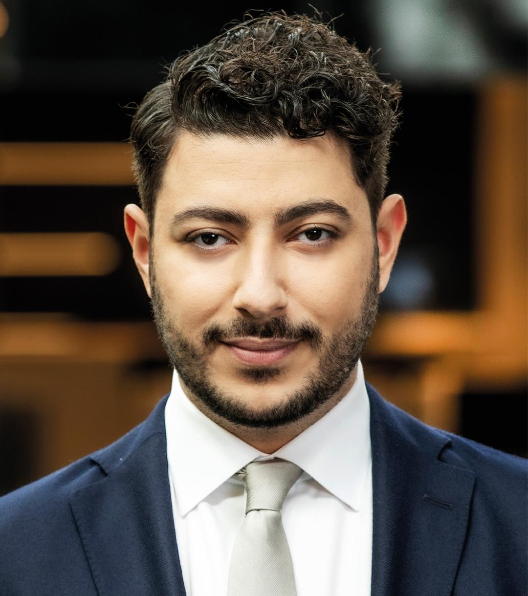 a man smiling and looking into the camera