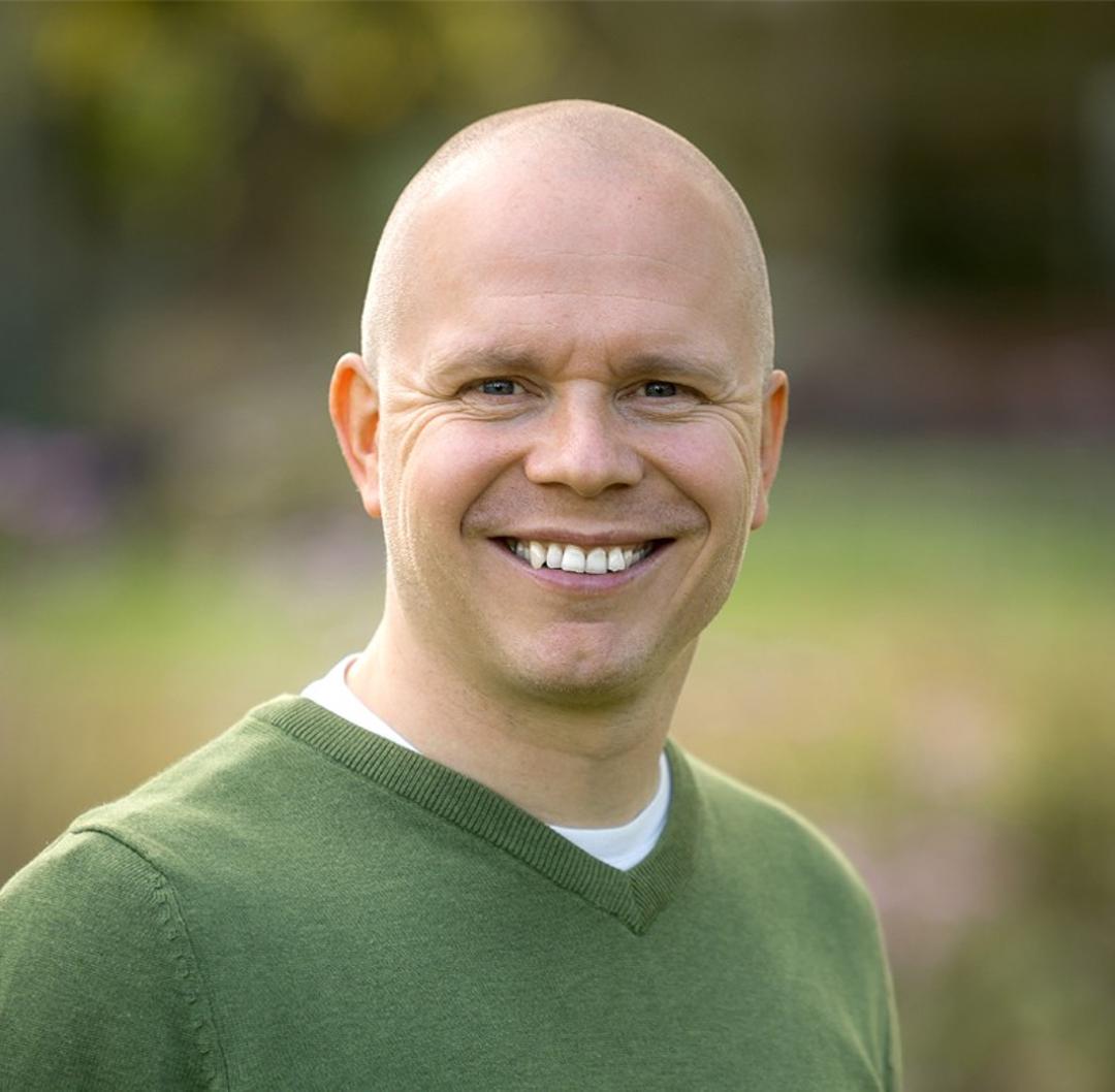a man smiling and looking into the camera