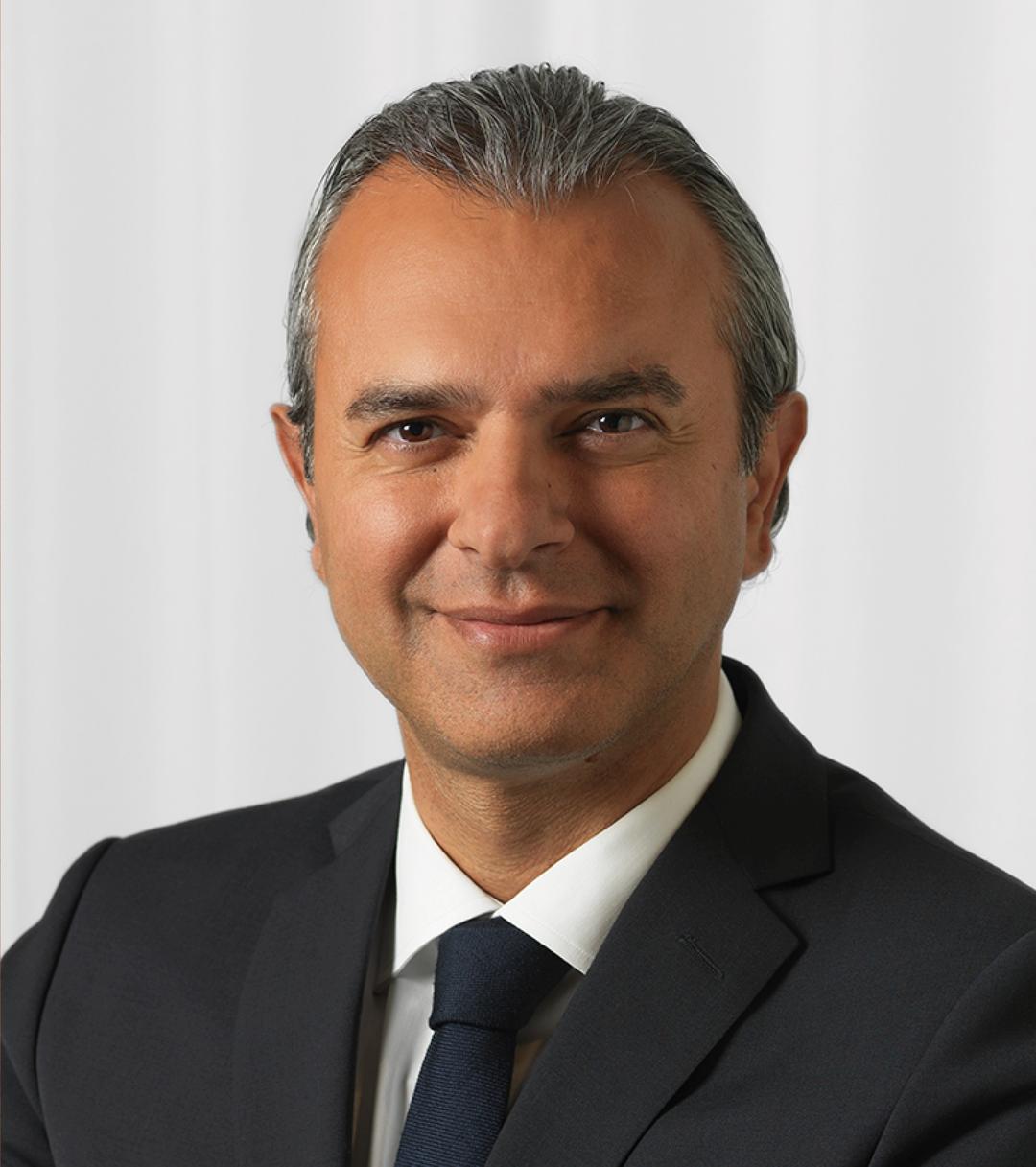 a man smiling and looking into the camera