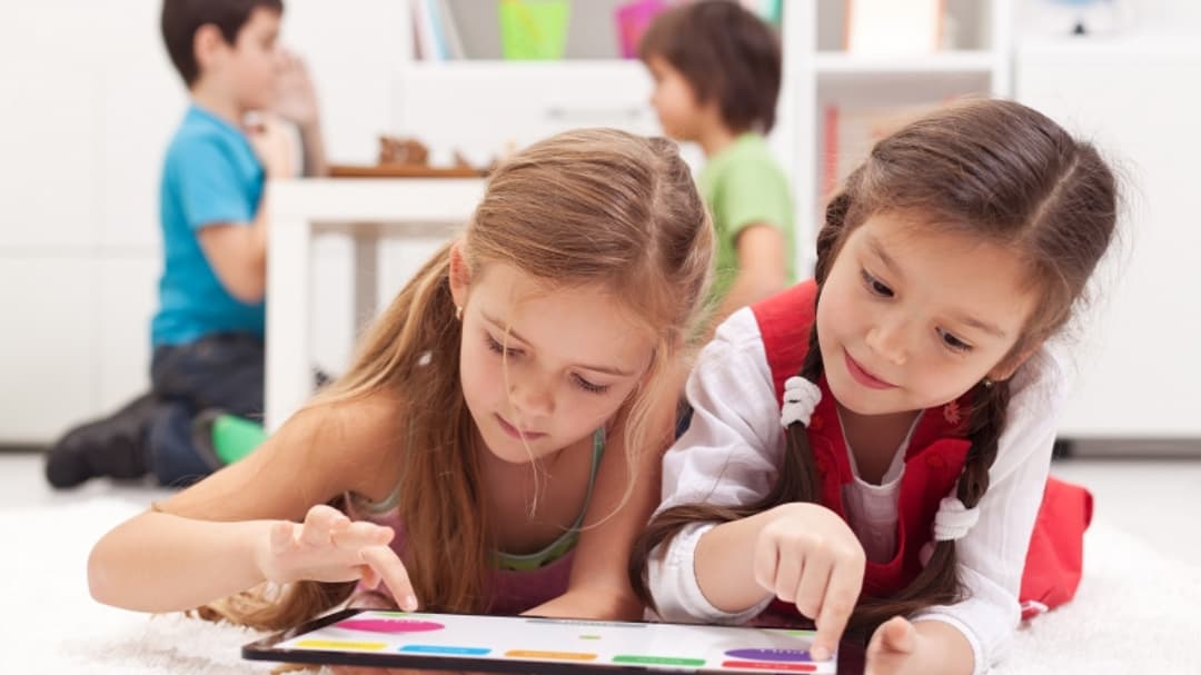 4427598-little-girls-playing-on-a-tablet-computing-device.jpg