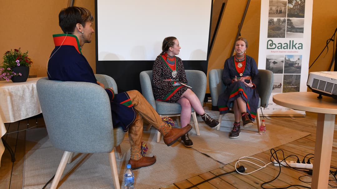 Tre personer sitter i ett panelsamtal.