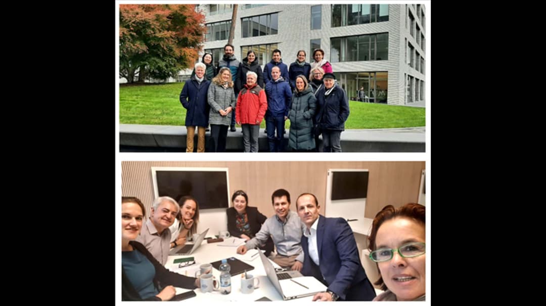 Two pictures with people. In the upper picture, thirteen people are standing outside in front of a building. In the lower picture, seven people are sitting around a table with computers in front of them.  