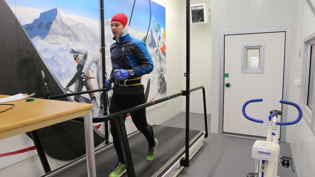 Winter dressed man on treadmill indoors