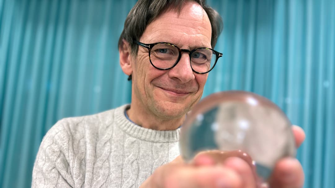 a man holding a crystal bowl