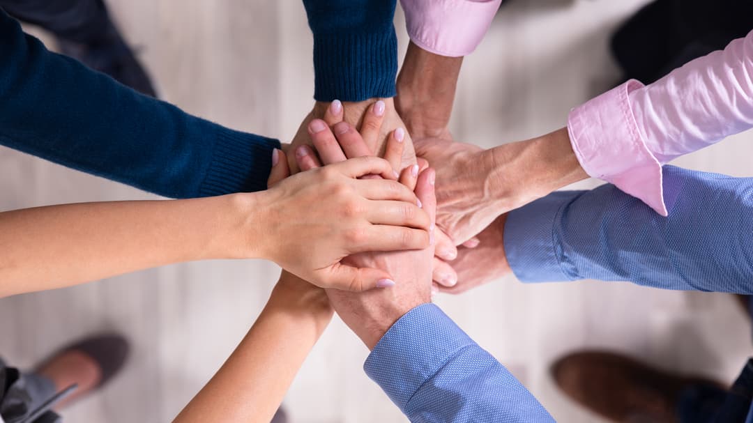 31236205-businesspeople-stacking-hands-over-each-other.jpg