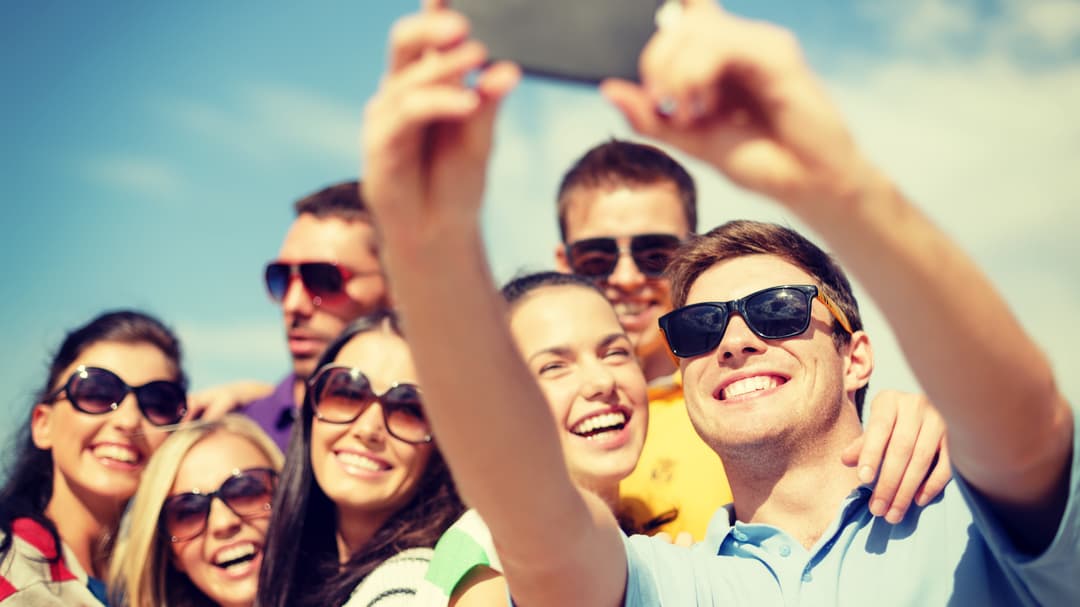 8699060-group-of-friends-taking-picture-with-smartphone.jpg