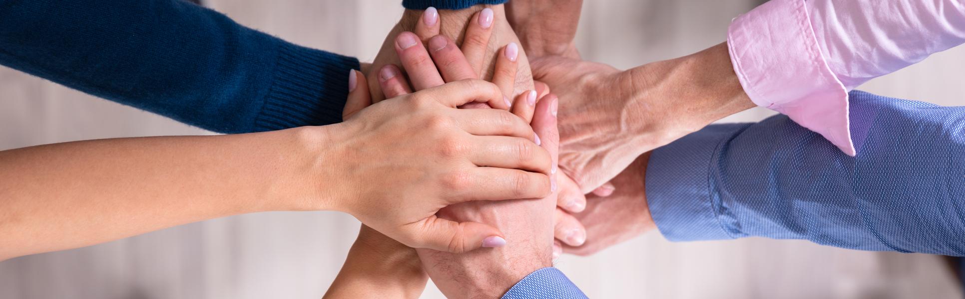 31236205-businesspeople-stacking-hands-over-each-other.jpg