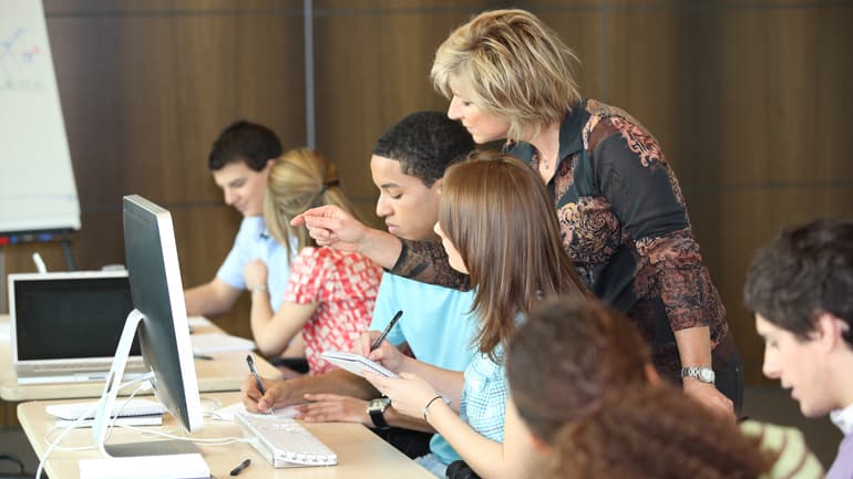 2818613-group-of-students-looking-at-a-computer-with-a-teacher.jpg