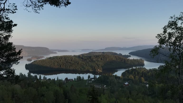 View of forested islands in calm water.