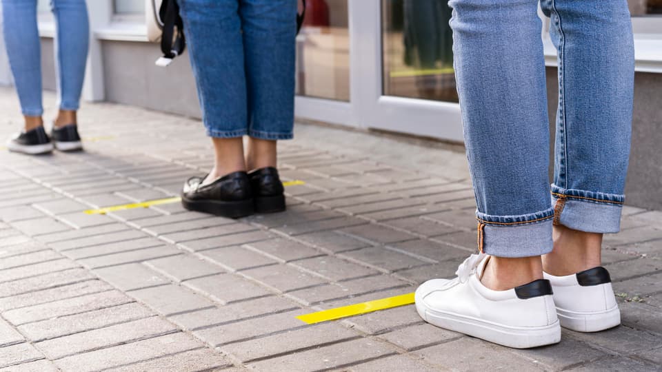 People standing in line one meter apart.