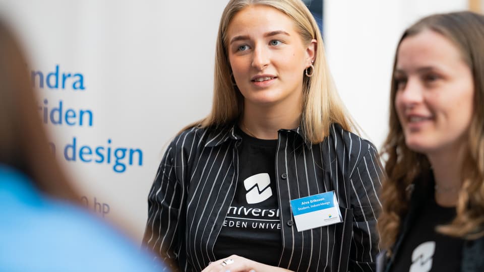 Two student ambassadors working in a booth.