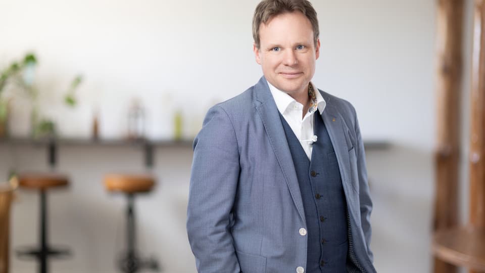 Portrait of a man in a blue blazer.