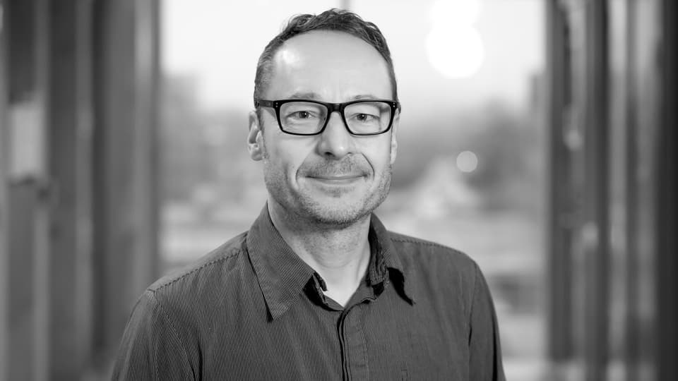  A black and white image of a man looking into the camera.