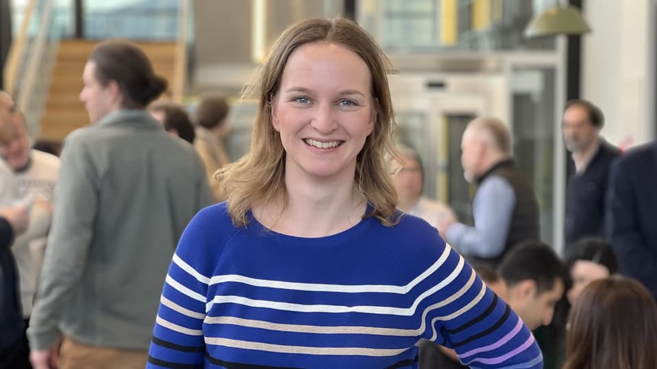  A smiling woman looks into the camera.