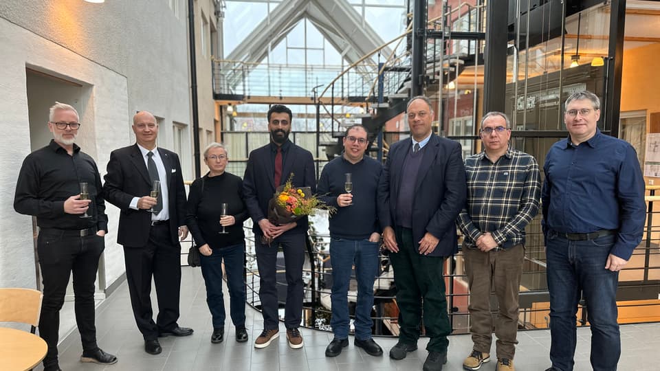 A group picture of eight well dressed people