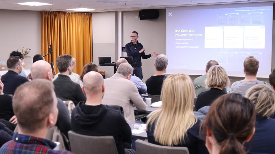 A man stands in front of an audience and speaks.