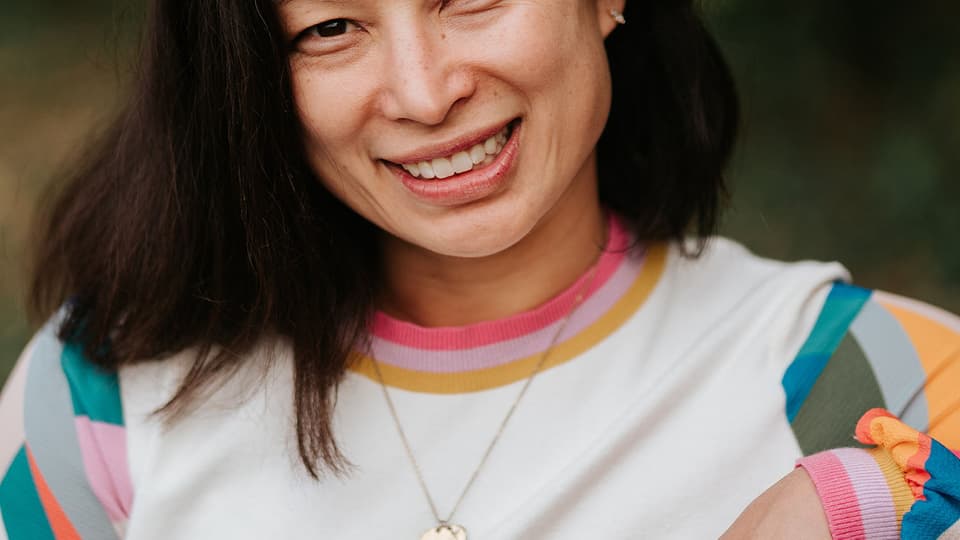 A portrait photo of a woman with dark hair