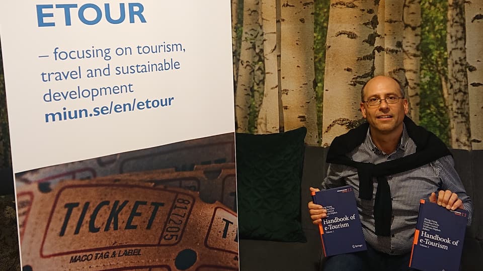 Matthias Fuchs with a new book in his hand - Handbook of e-Tourism