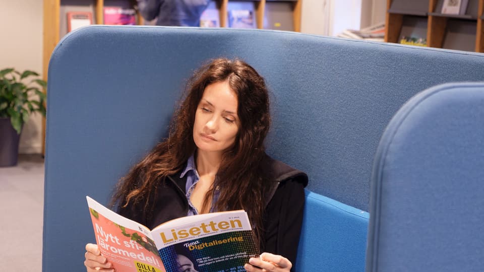 Woman reading a paper at a library