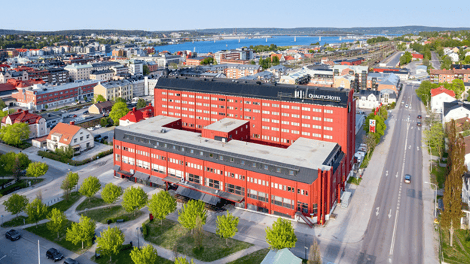 A red hotel building in an urban environment.