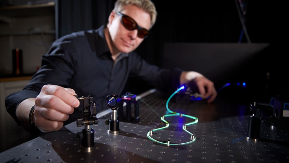 Researcher working with fiber optics.