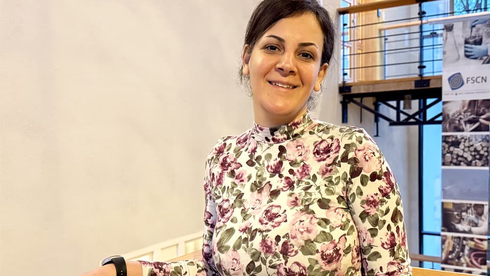 Portrait of a woman in a floral sweater.