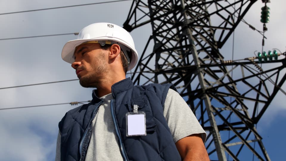 3498480-worker-standing-in-front-of-an-electricity-pylon.jpg