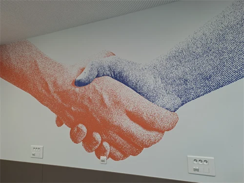 Handshake with two digital hands in different colours.