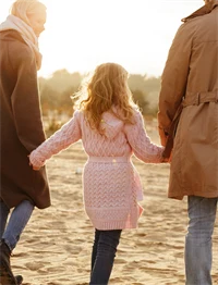 a woman, a child a man, seen from behind
